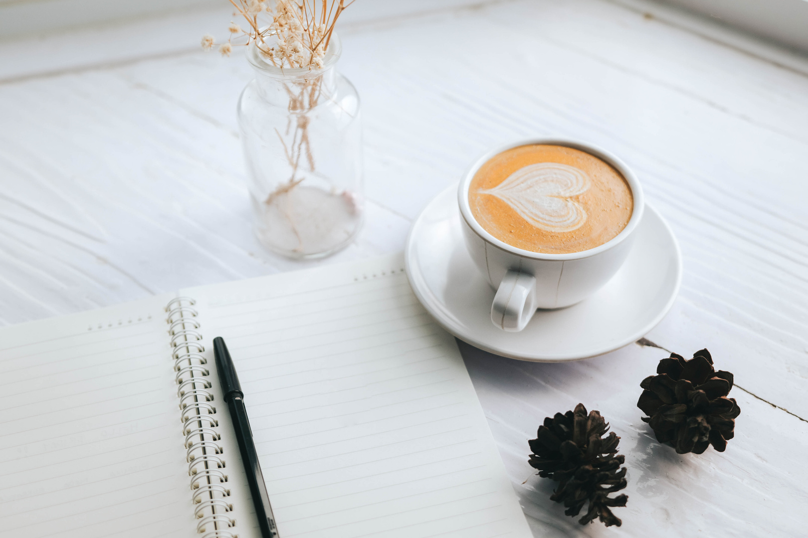 Notebook and Coffee on a Table